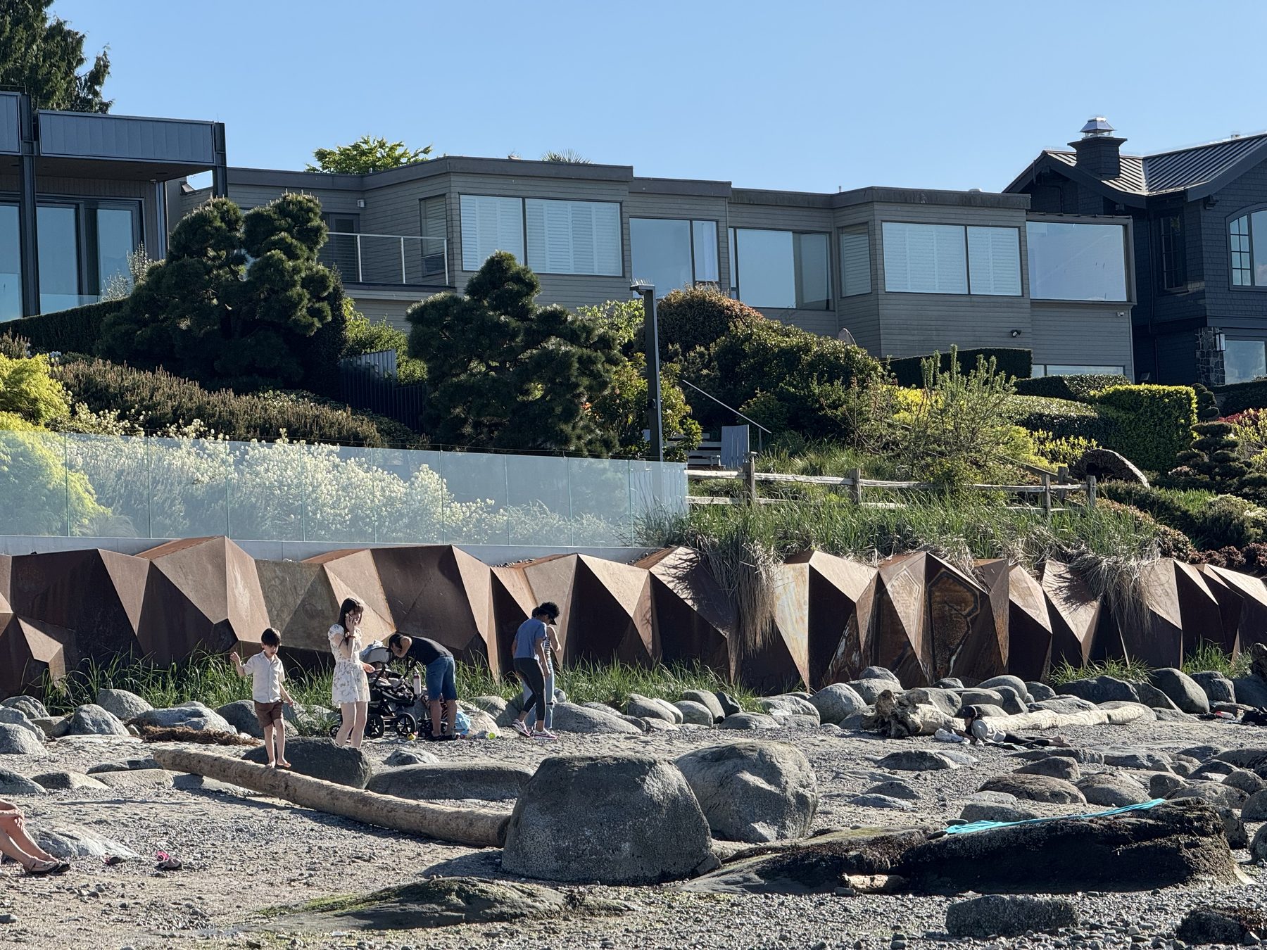 West Side waterfront homes, shoreline planting, beach stones, and edge conditions