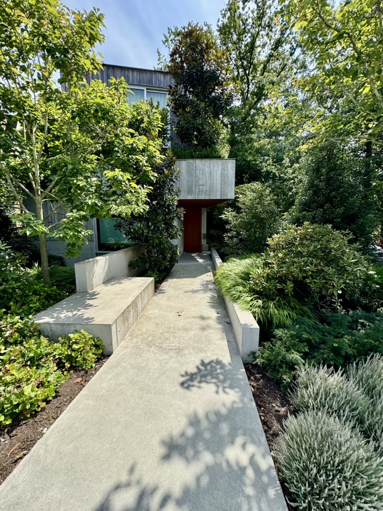 Modern Vancouver West Side home entry framed by mature planting