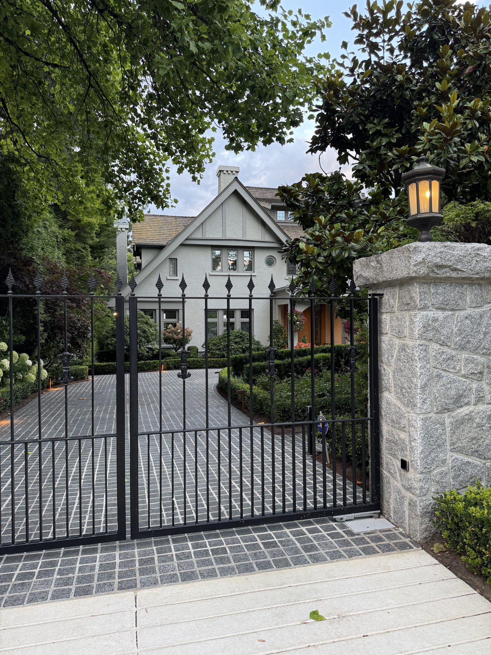 Gated Vancouver Westside home framed by mature trees and planting